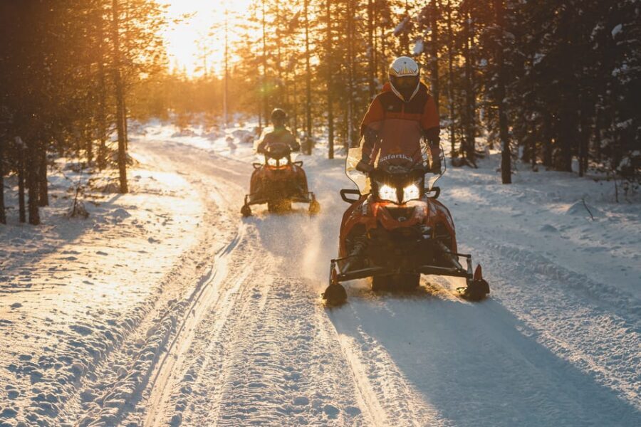 Rovaniemi: Family Snowmobile Trip with Guide and Picnic - Kids on the mini-snowmobile and sled ride: where fairness can get tricky